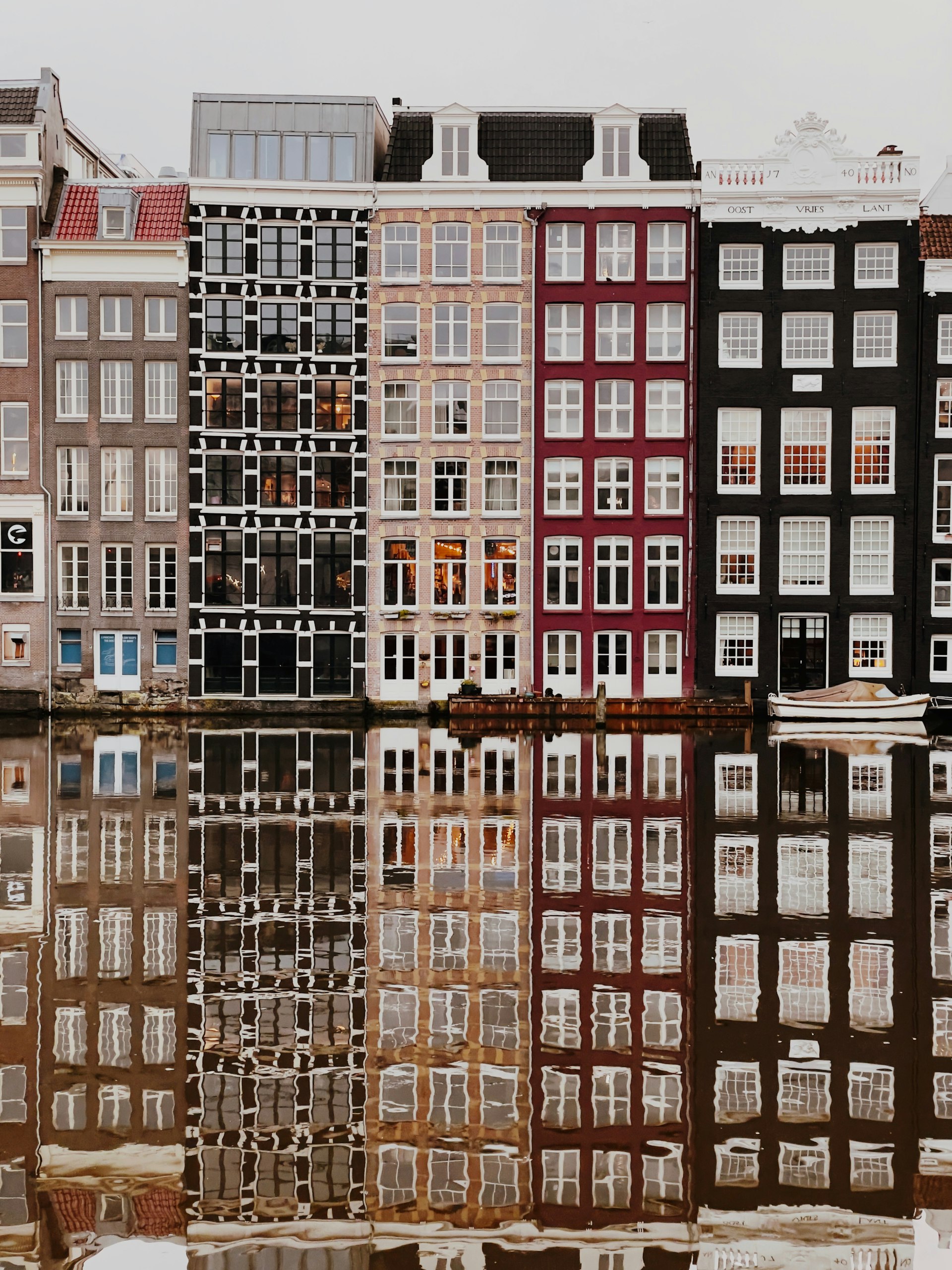 The narrow gabled facades of a row of canal houses in Amsterdam